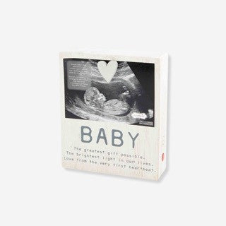 Unique baby gifts collection featuring framed photo keepsakes, plush moon toys, personalized books, and colorful baby bibs